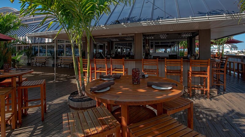 Outdoor dining patio with outdoor bar in background