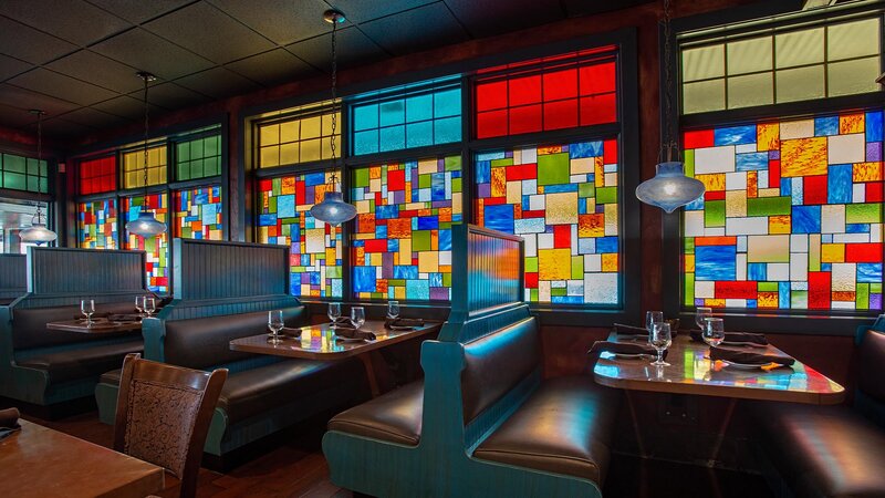 Indoor dining area with booths and stain glass windows